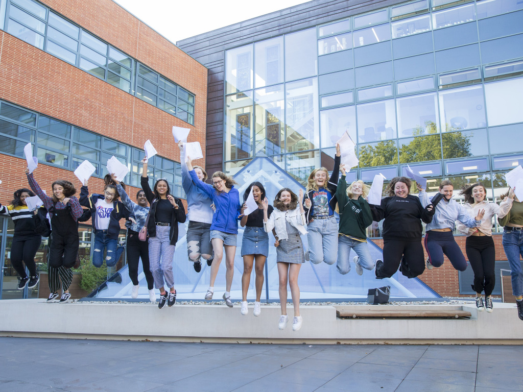 GCSE students jumping from pyramid