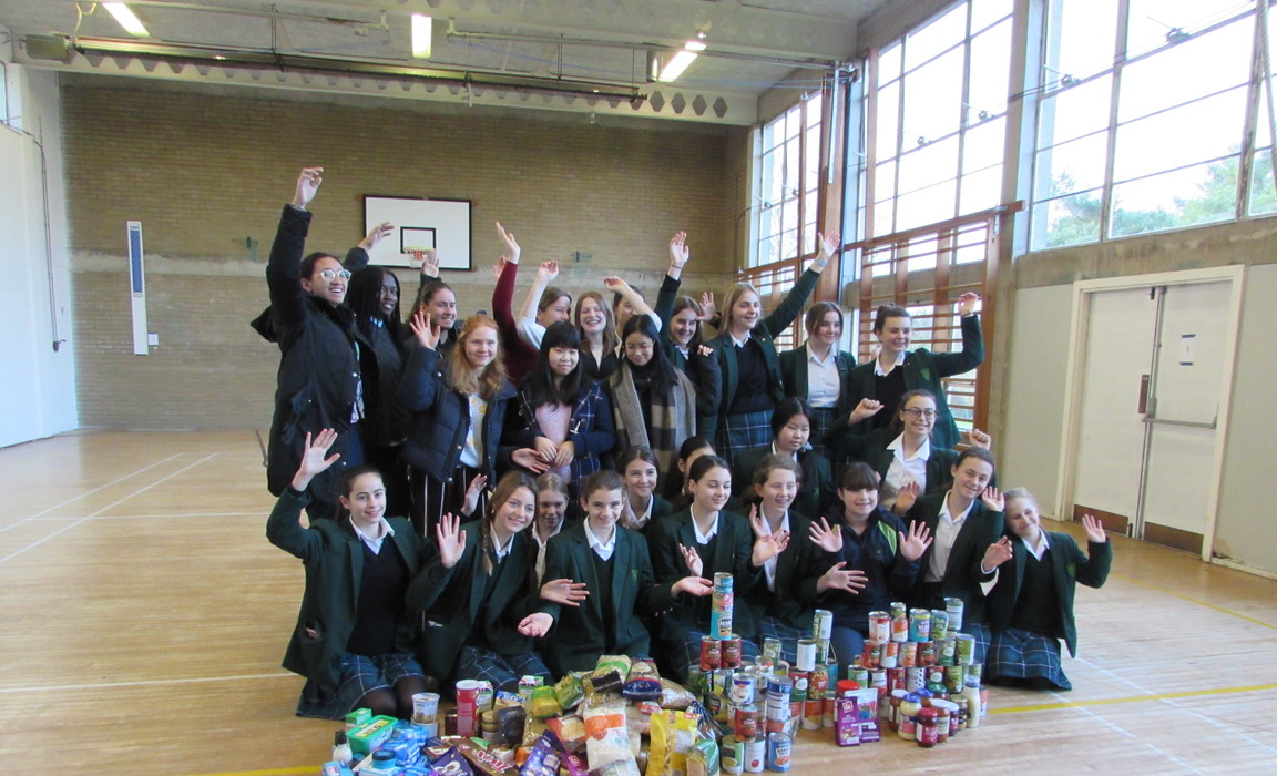 Girls from Montacute Hall at Bruton School for Girls with some of the items collected for the local food bank.