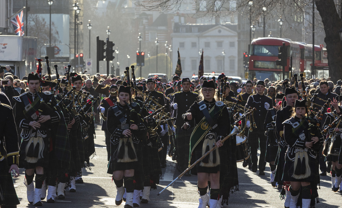 Bringing Whitehall to a standstill, the Gordon's School students led by their Pipes and Drums. The school makes an annual parade to the statue of Gene