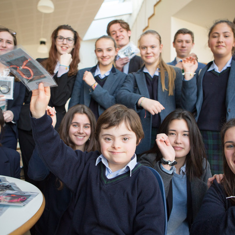 Lucas and Gresham's students holding braclets