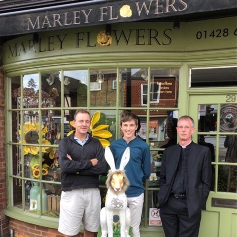 photo taken outside Harvey’s mother’s flower shop, shows HAREcules, CFA’s Lawyer Group member, Christian Parker with Harvey King & Rev David Standen.