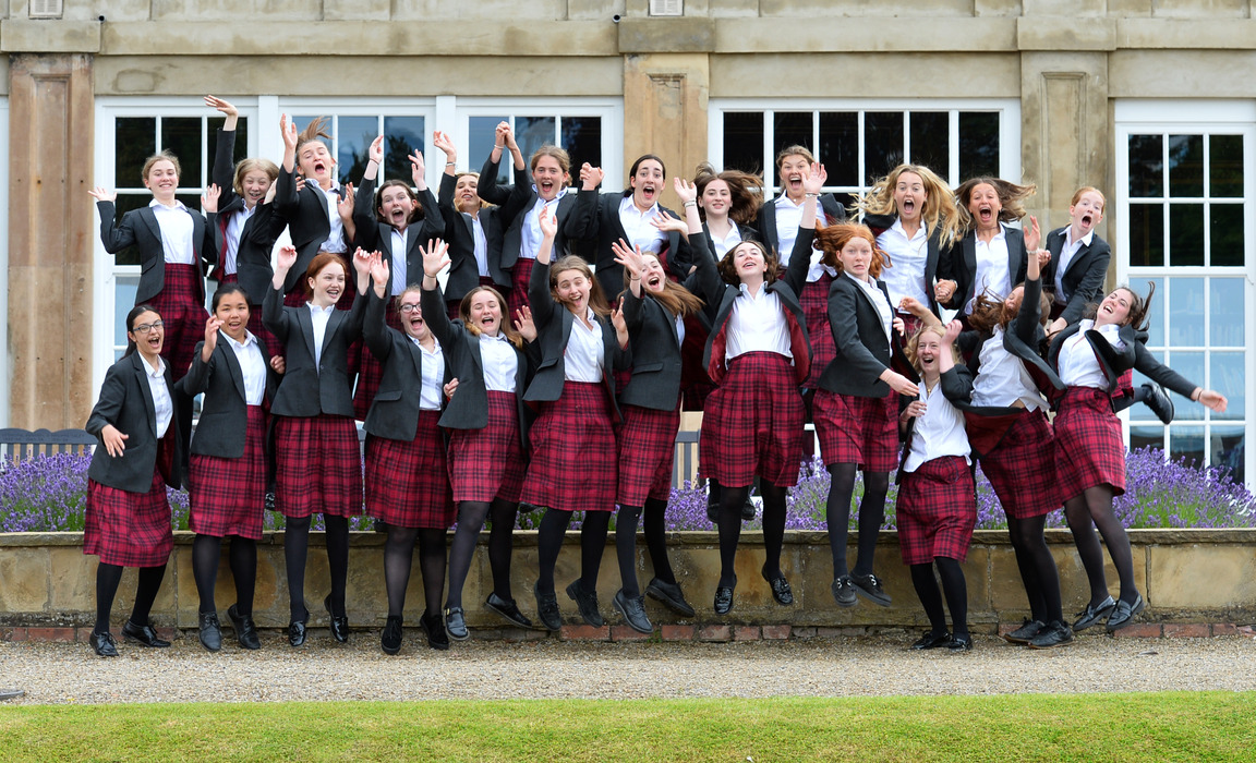 Queen Margaret's Year 11 girls jumping for joy