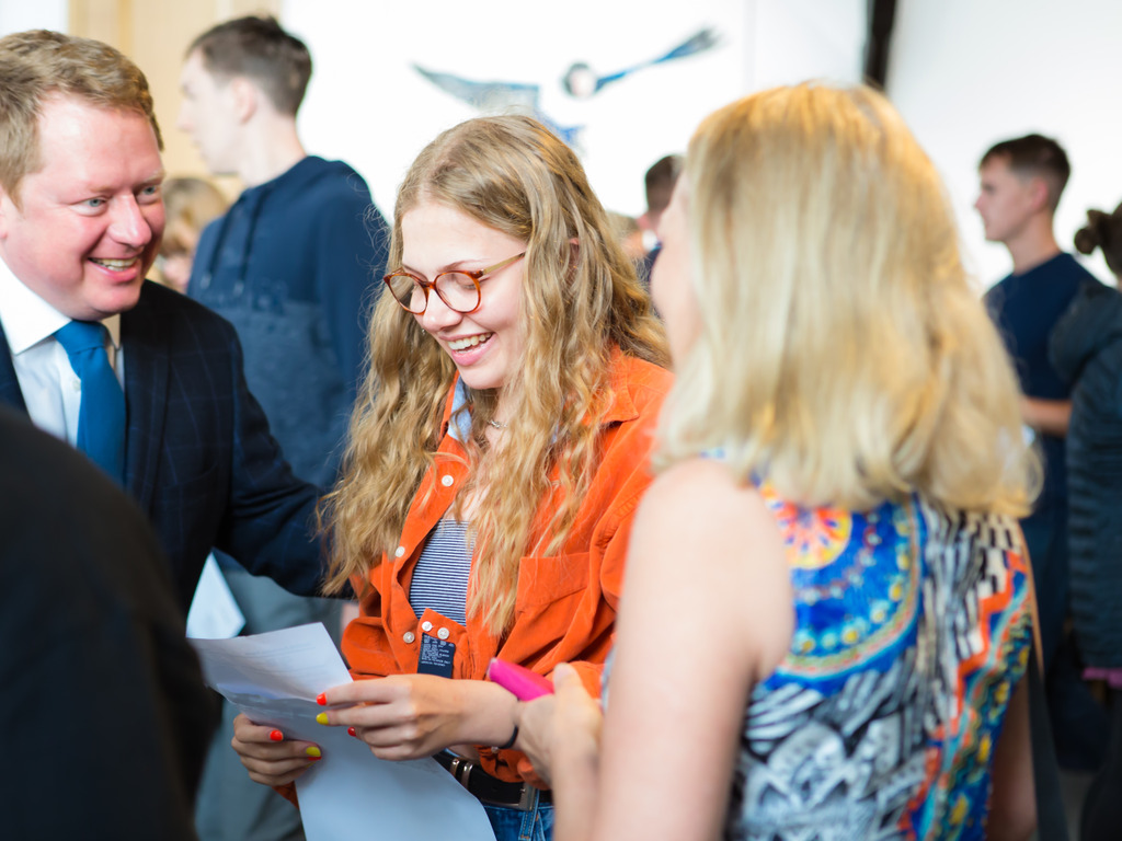 RGS Headmaster Shaun Fenton shares in the delight of a happy pupil and her parents
