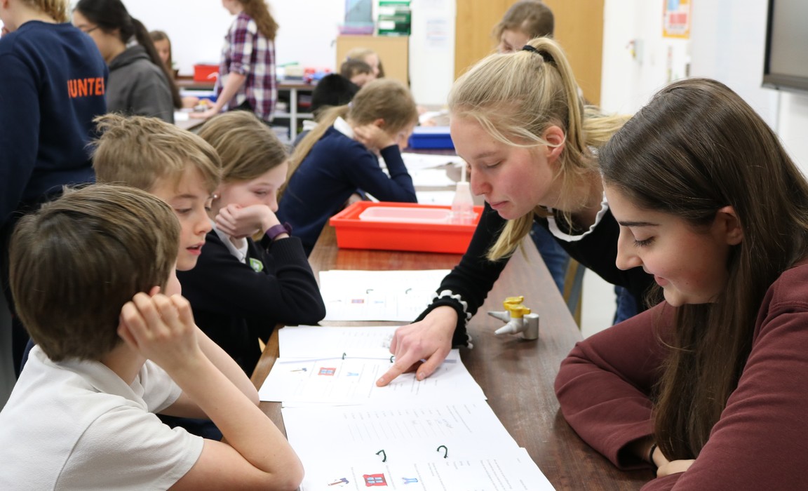 St Swithun’s pupils running a science activity.