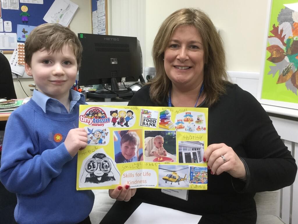 Leo in Reception demonstrates his 'kindness' skill to Mrs Dodsworth, Headmistress