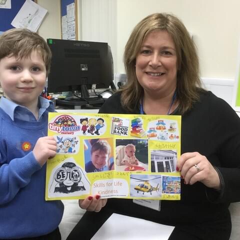 Leo in Reception demonstrates his 'kindness' skill to Mrs Dodsworth, Headmistress